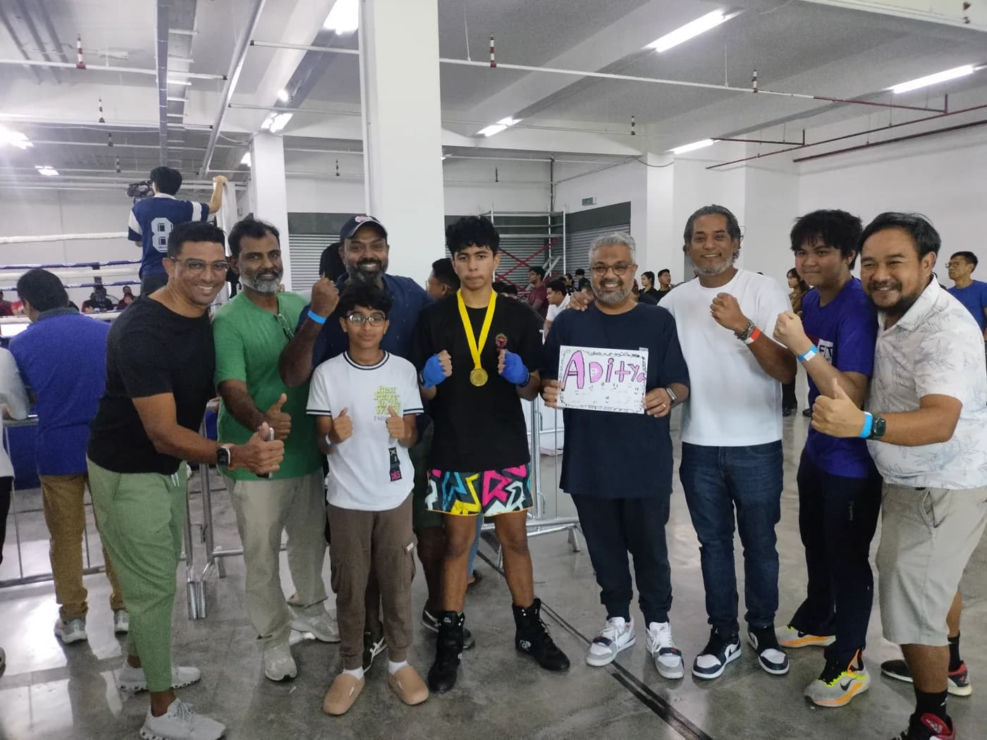AZMA athletes and supporters celebrating a gold medal together